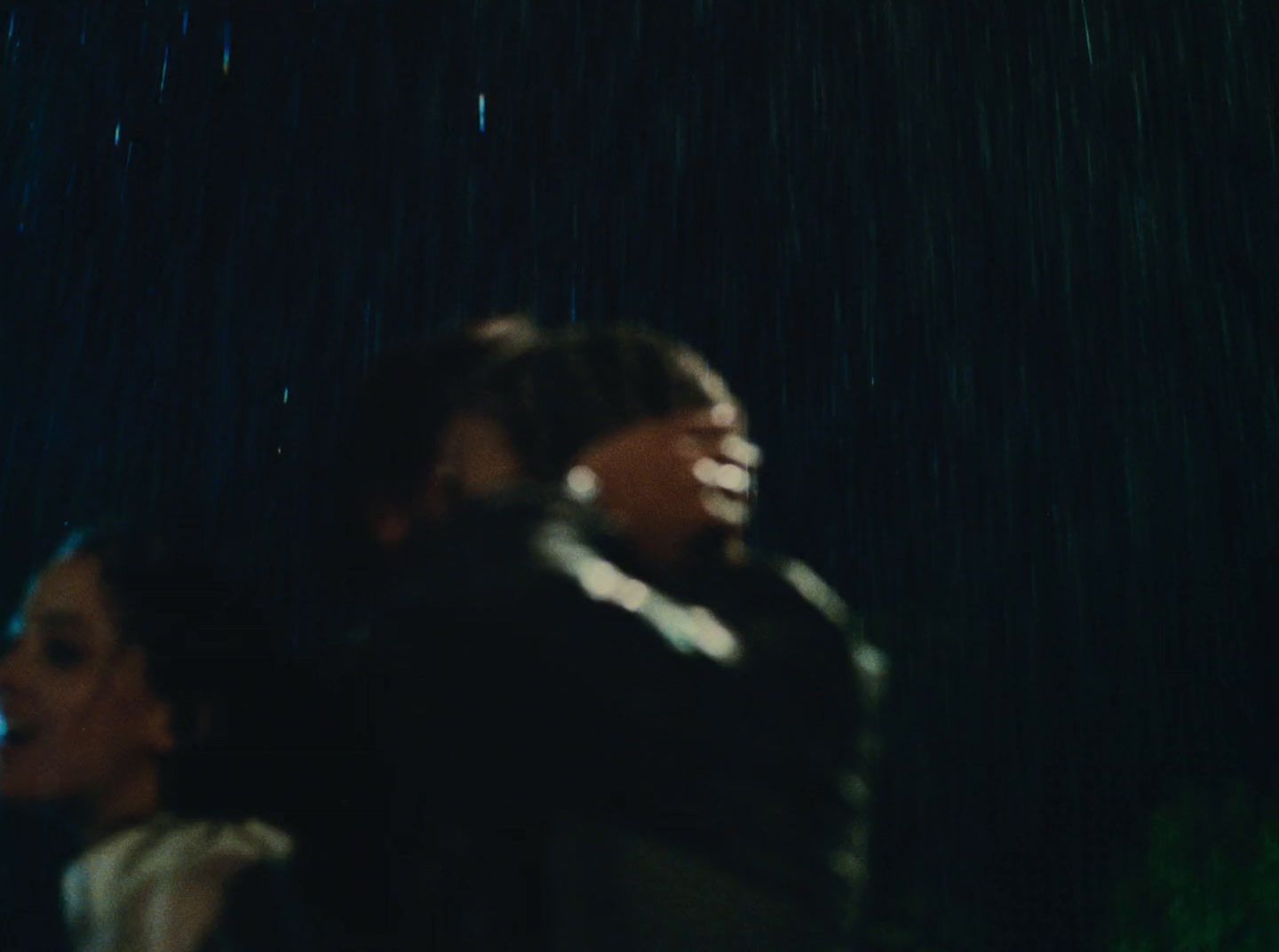 a man and a woman standing in the rain