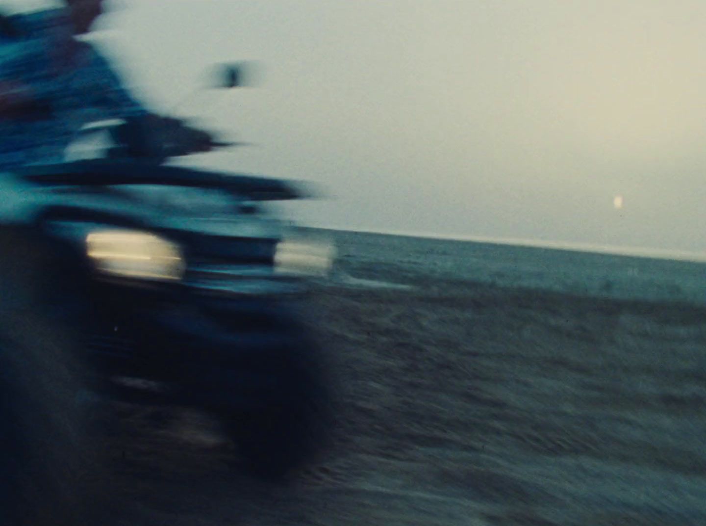 a blurry photo of a person riding a motorcycle