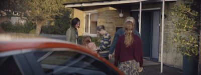 a group of people standing outside of a house