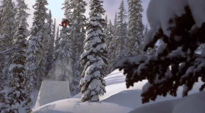 a person jumping a snow board in the air