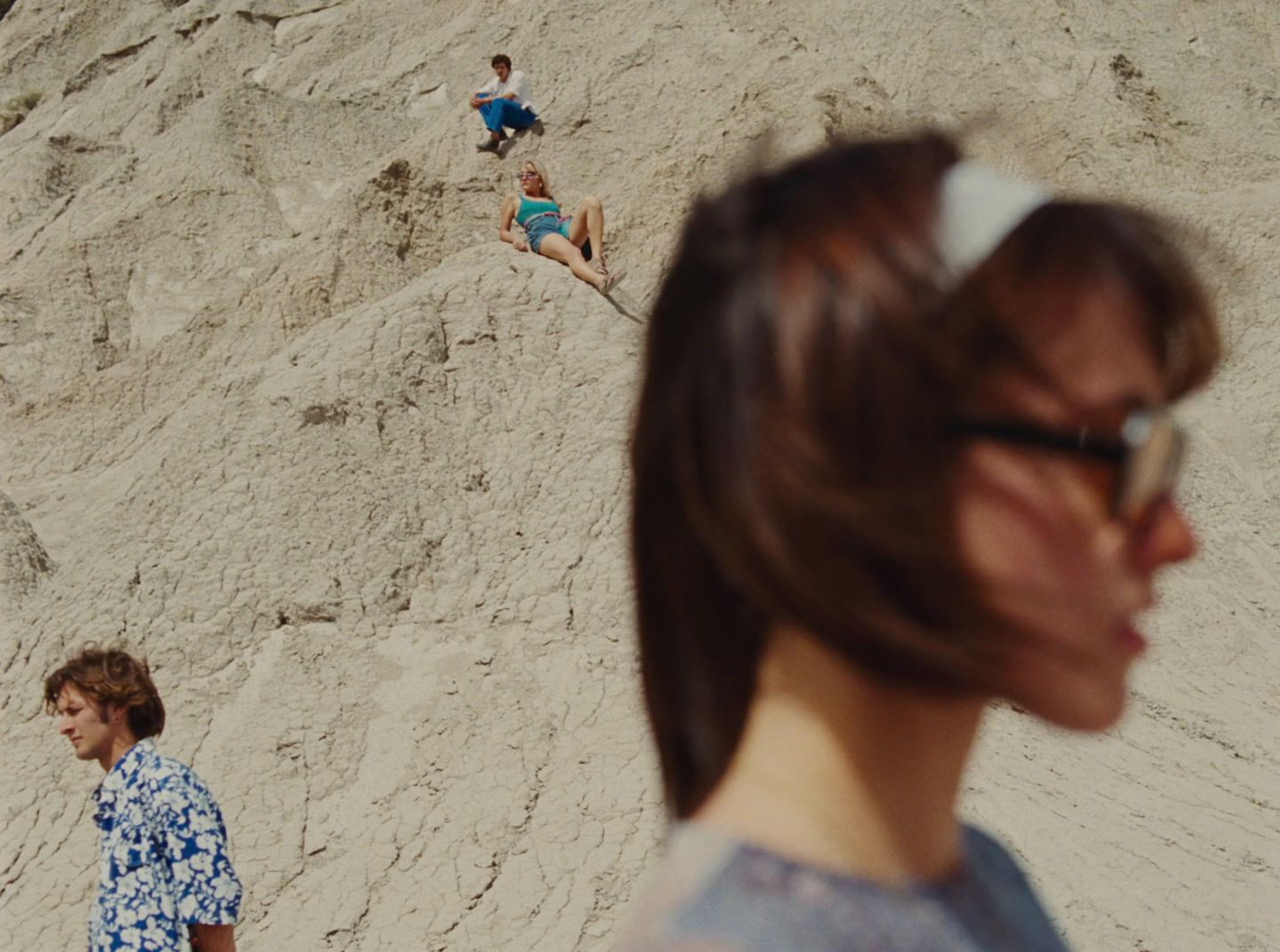 a group of people standing on top of a sandy beach