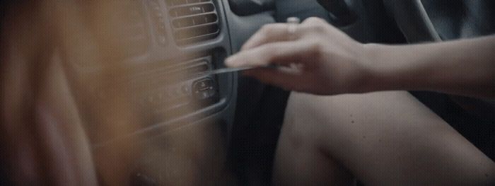 a person is holding the steering wheel of a car