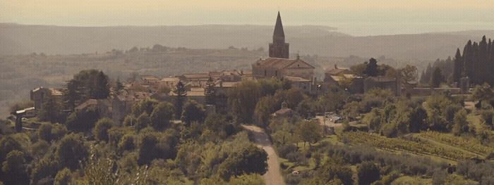 a small village with a church on top of a hill