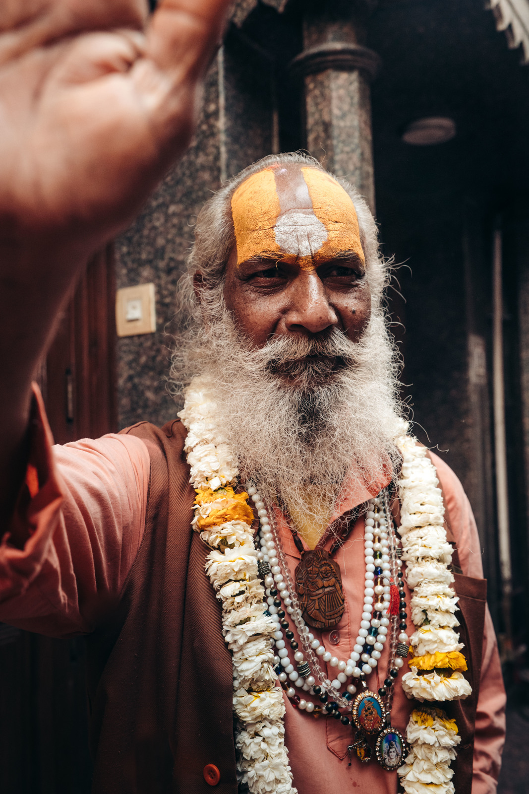 a man with a white beard wearing a yellow and white headdress