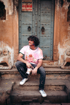 a man sitting on a step in front of a door