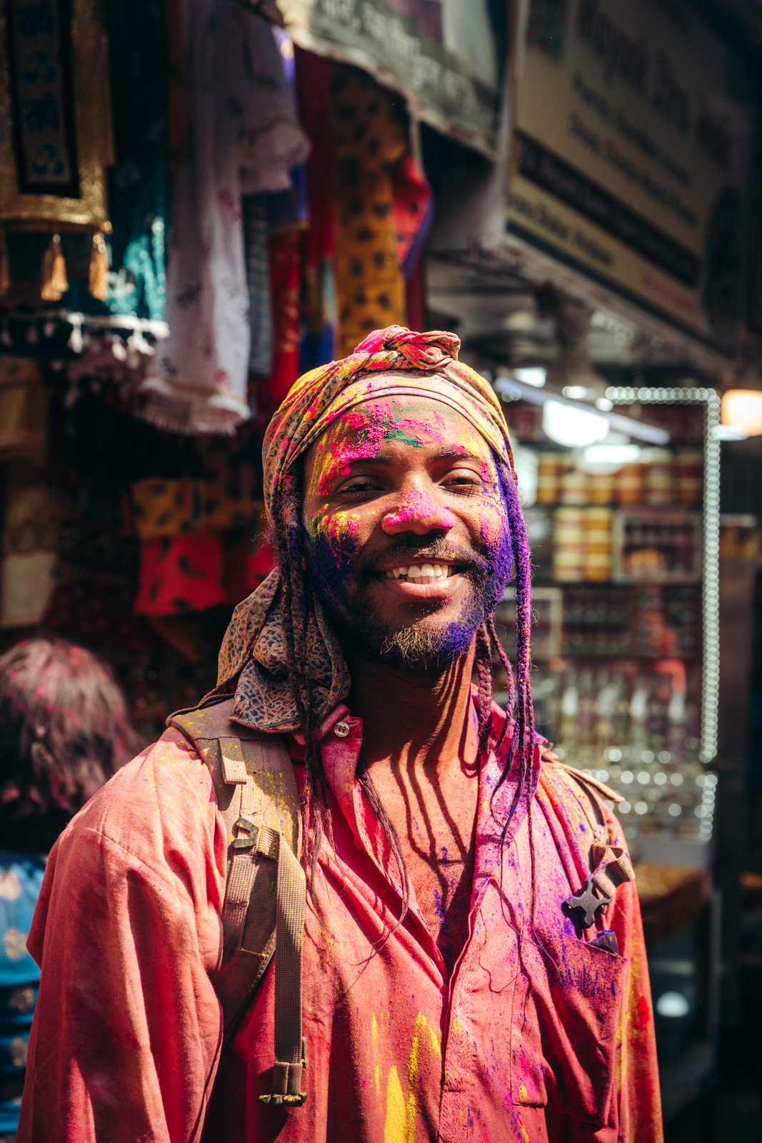 a man in a colorful turban smiles for the camera