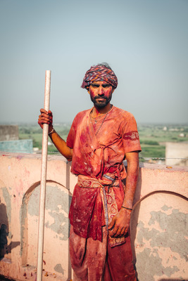 a man in a turban holding a stick