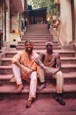 a couple of men sitting on top of a set of stairs