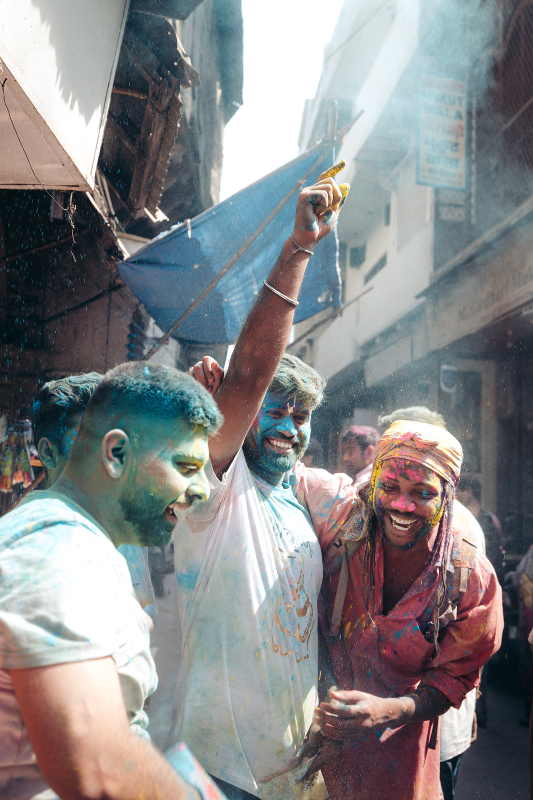 a group of people celebrating with colored powder on their faces