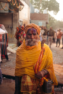 a man in a yellow turban holding a bucket