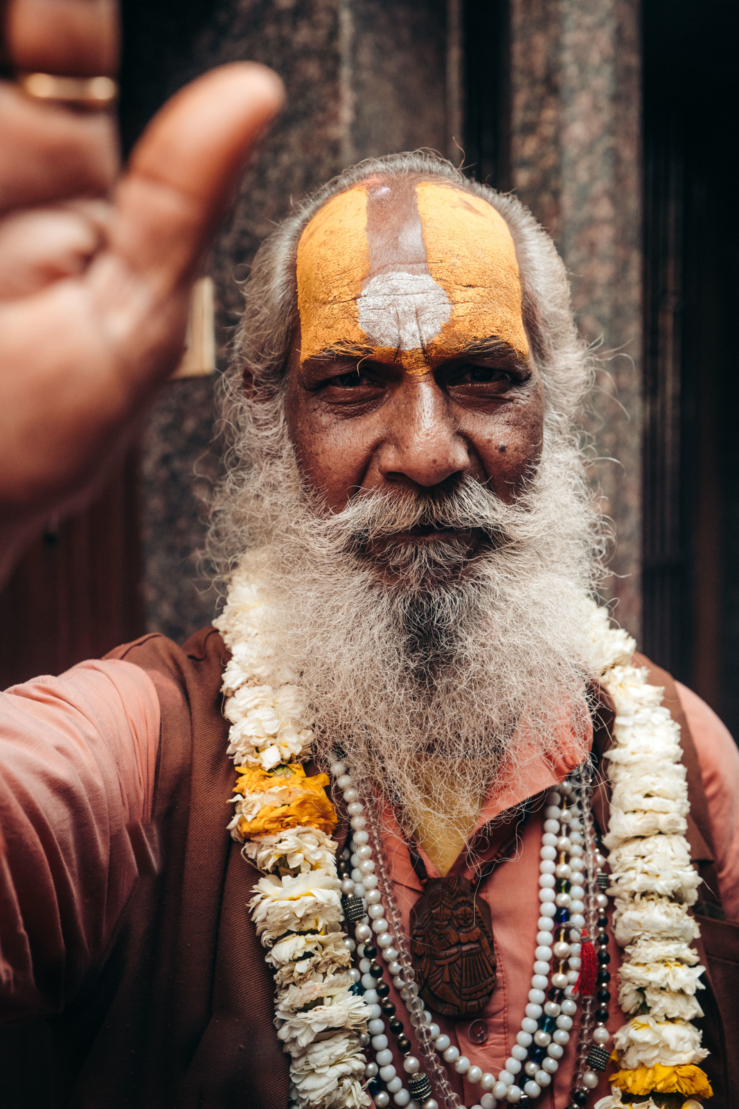 a man with a long beard wearing a yellow and white headdress