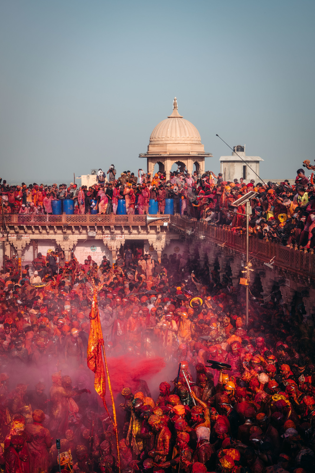 a large crowd of people standing around a building