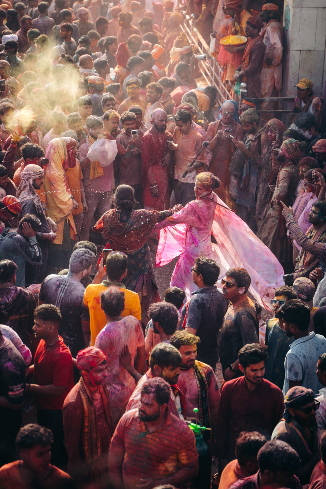 a crowd of people standing around each other