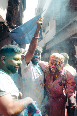 a group of people celebrating with colored powder