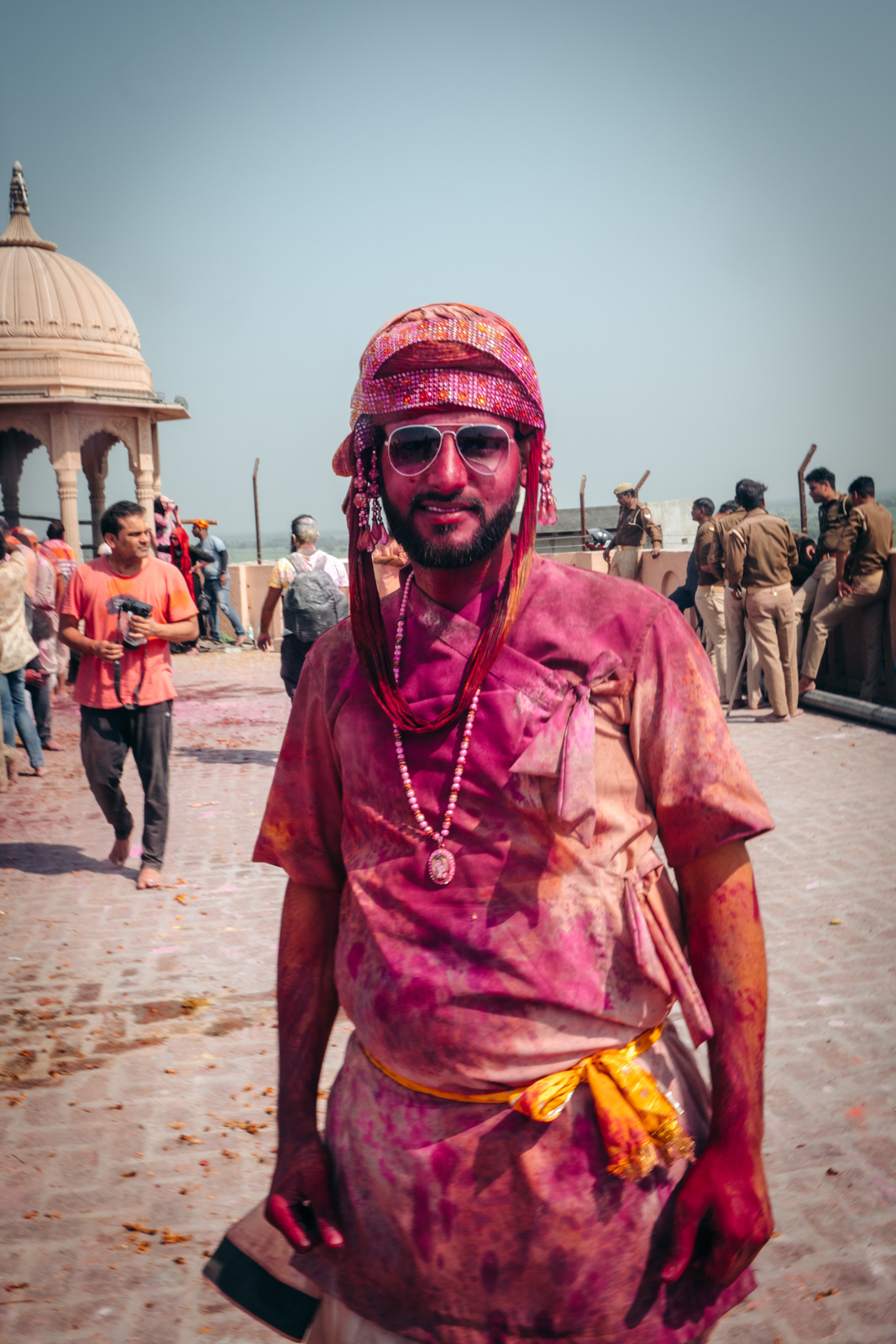 a man in a tie dye outfit standing in front of a group of people