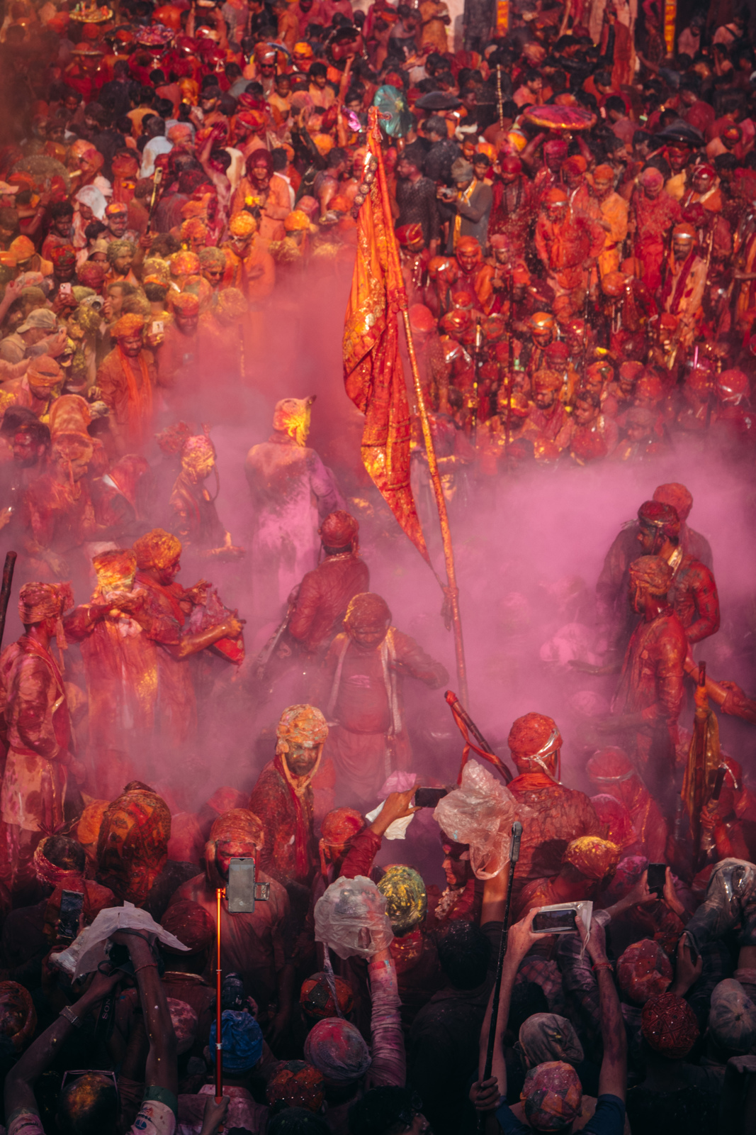 a large group of people standing around with colored powder