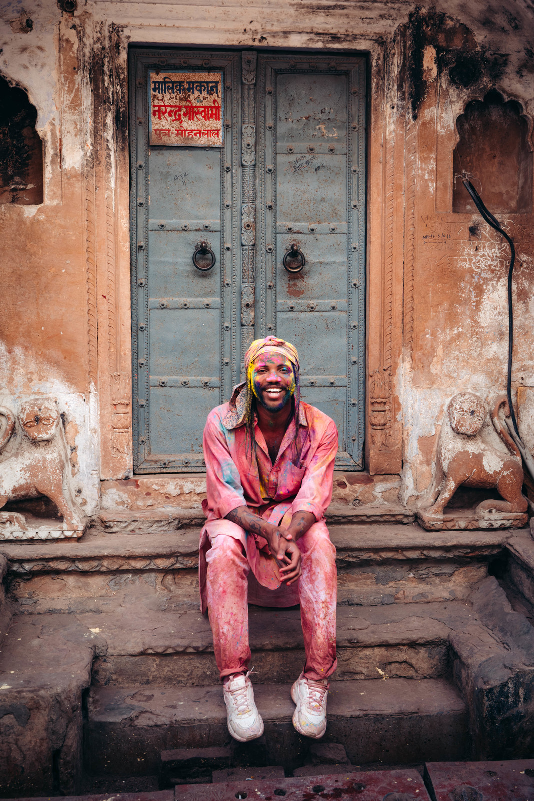 a man sitting on a step in front of a door