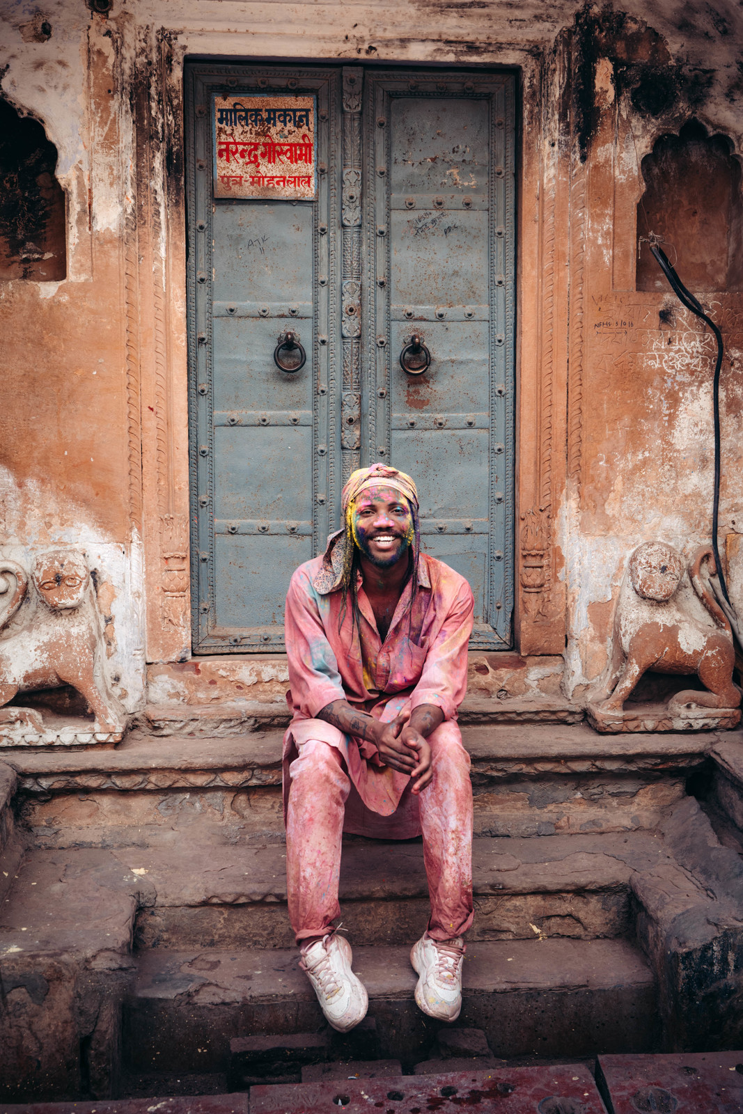 a man sitting on a step in front of a door