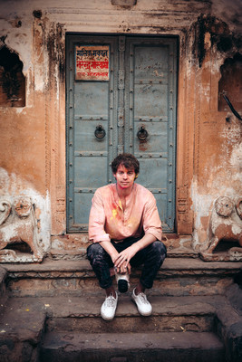 a man sitting on steps in front of a door