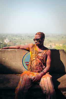 a man sitting on top of a cement wall