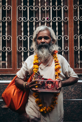 a man with a long beard holding a box