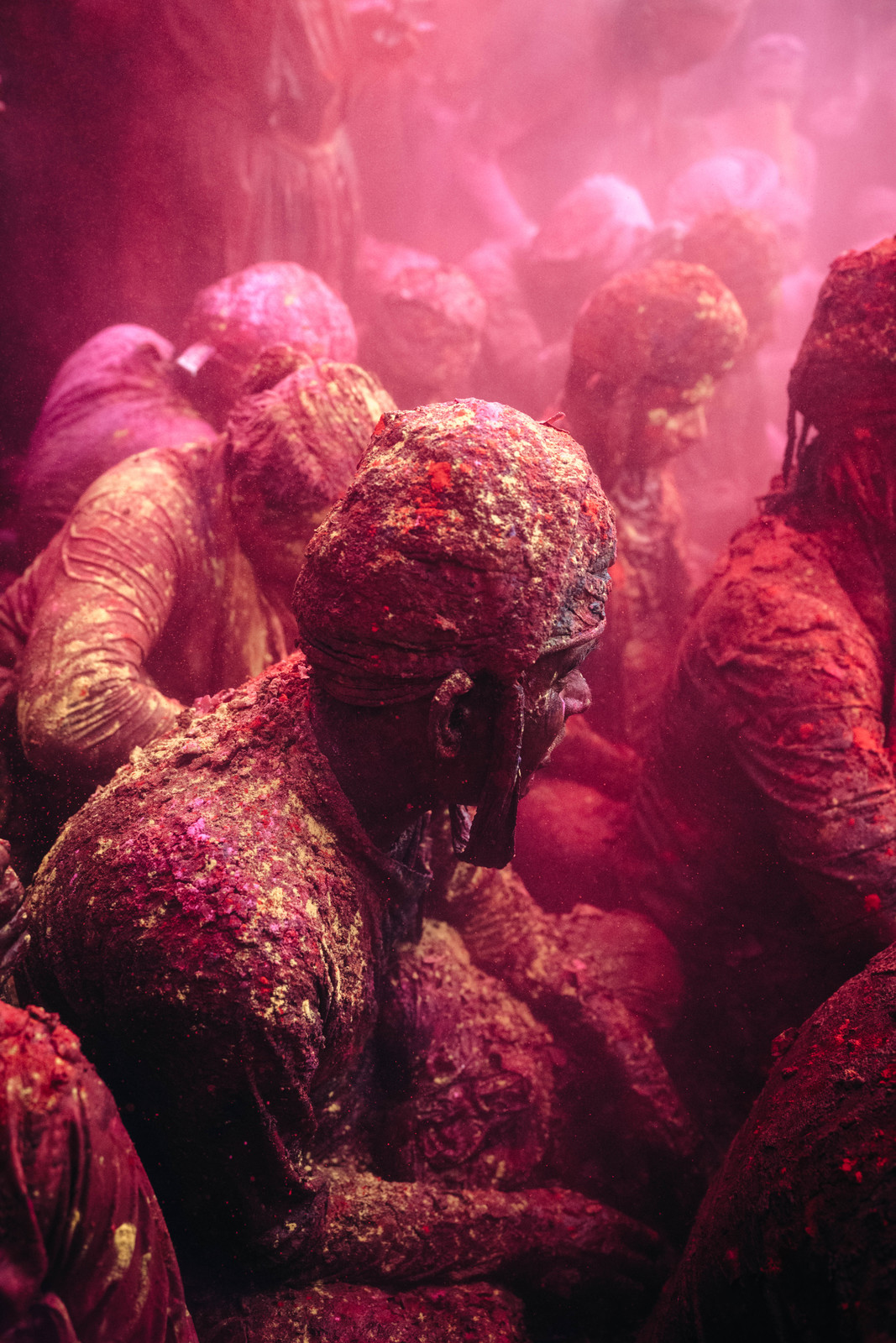 a group of people covered in colored powder