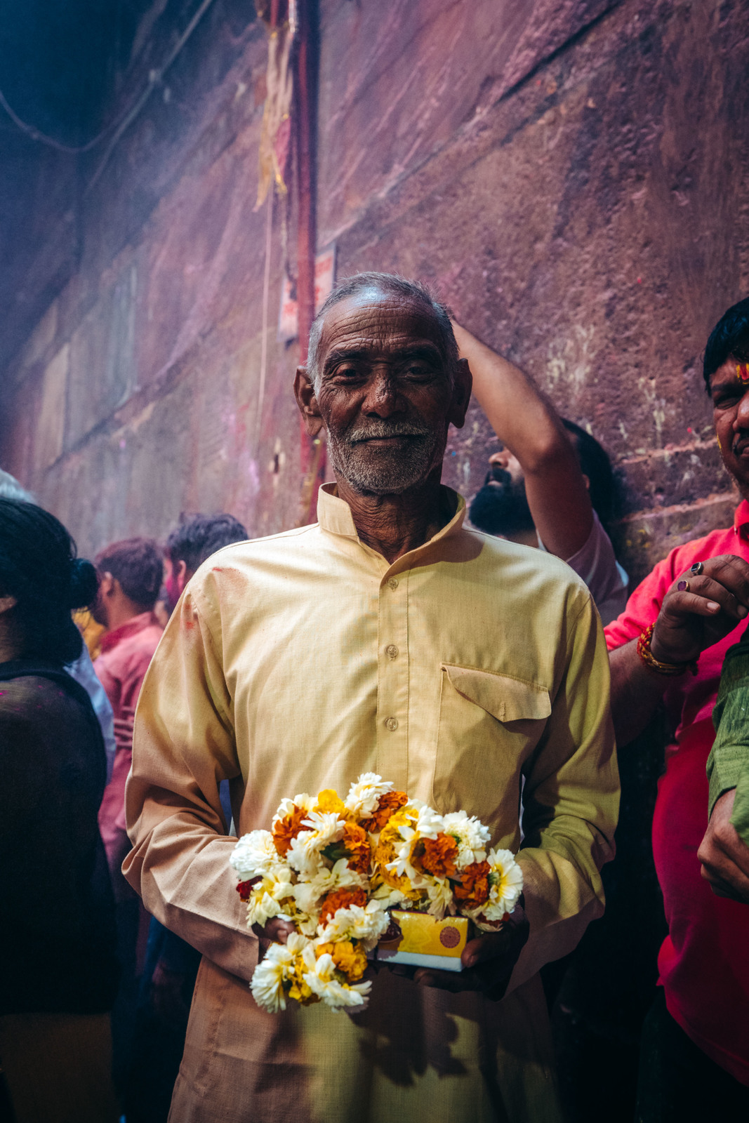 a man holding a bunch of flowers in his hands