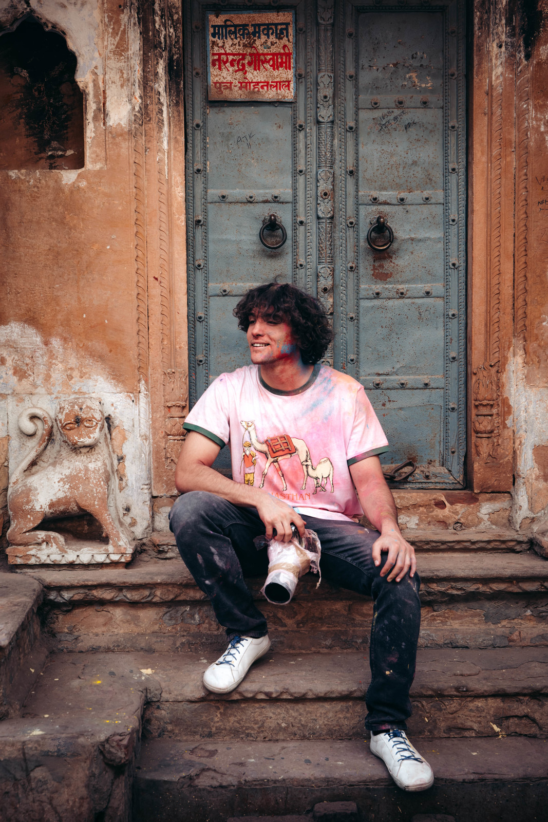 a man sitting on the steps of a building