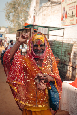 a man in a yellow and red sari