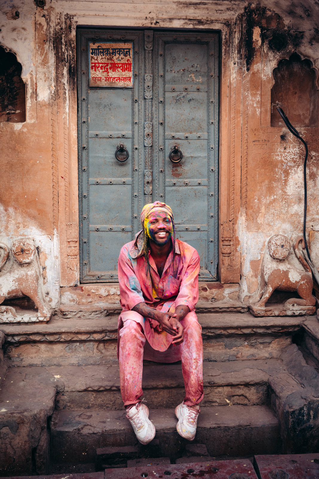 a man sitting on a step in front of a door