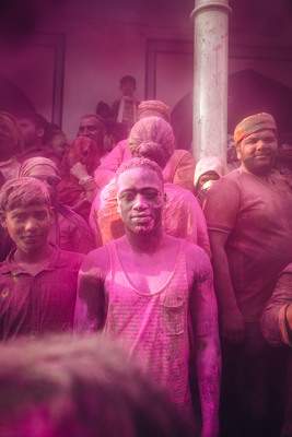 a group of people covered in pink powder