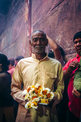 a man holding a bunch of flowers in his hands