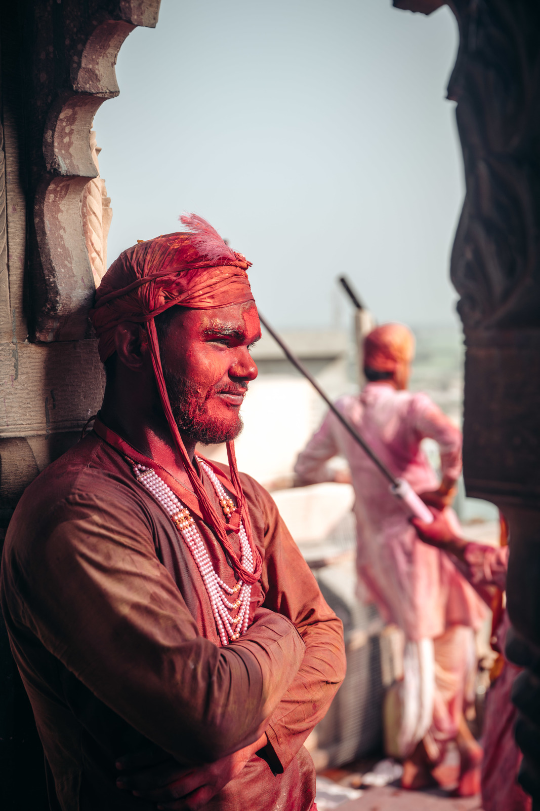 a man in a red turban standing next to another man