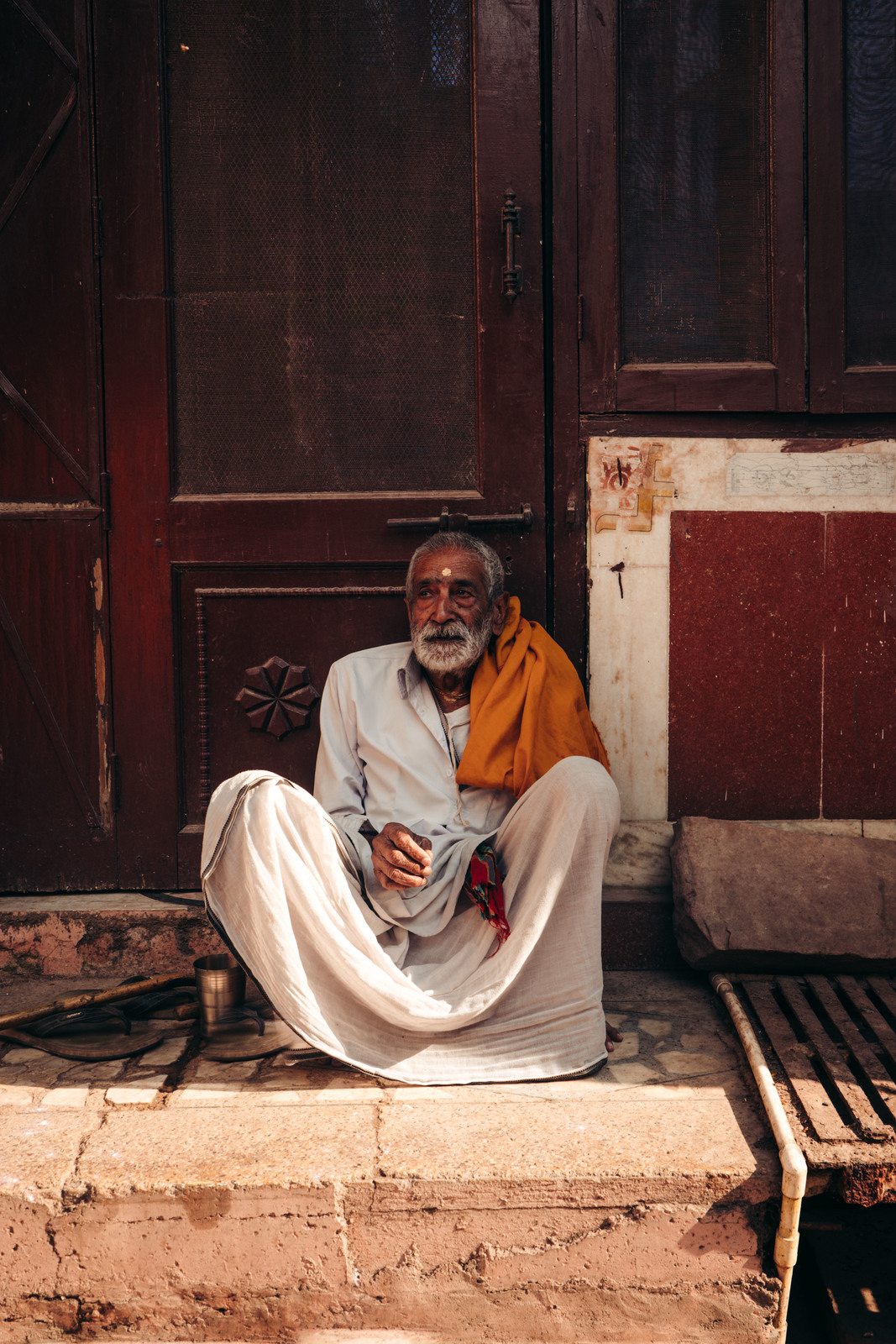 a man sitting on a step in front of a door