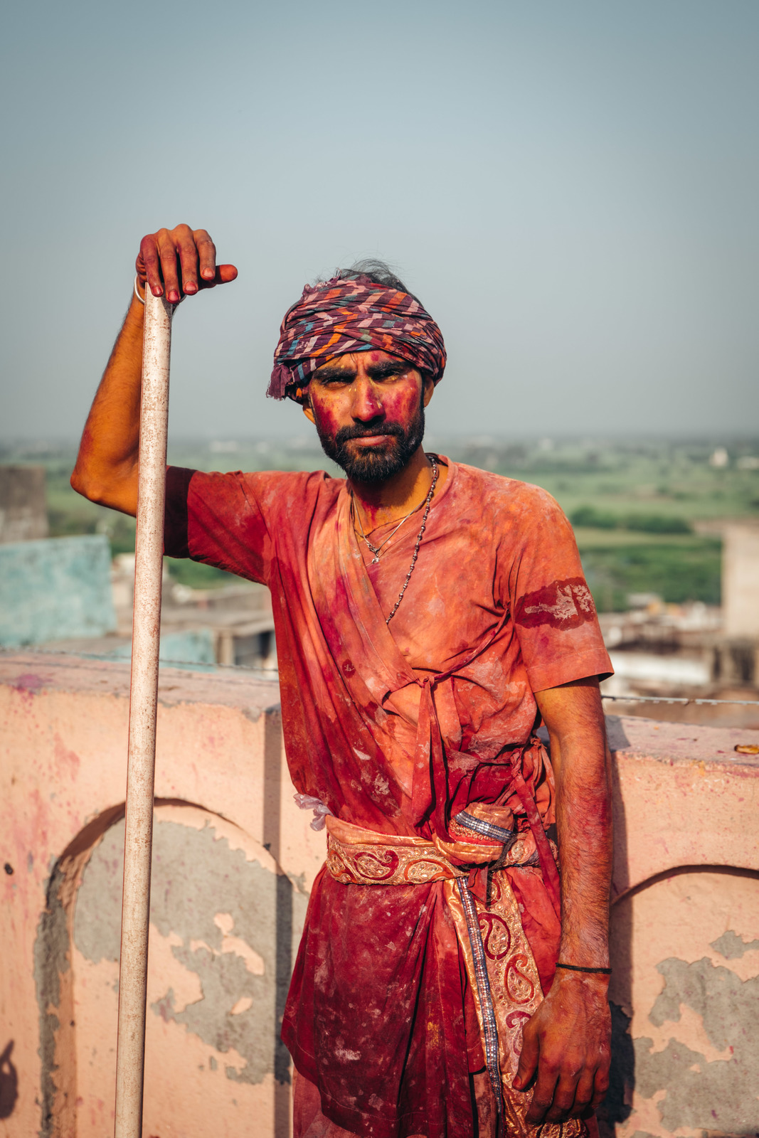 a man in a turban holding a stick