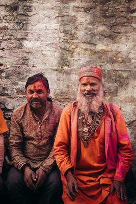 a couple of men sitting next to each other