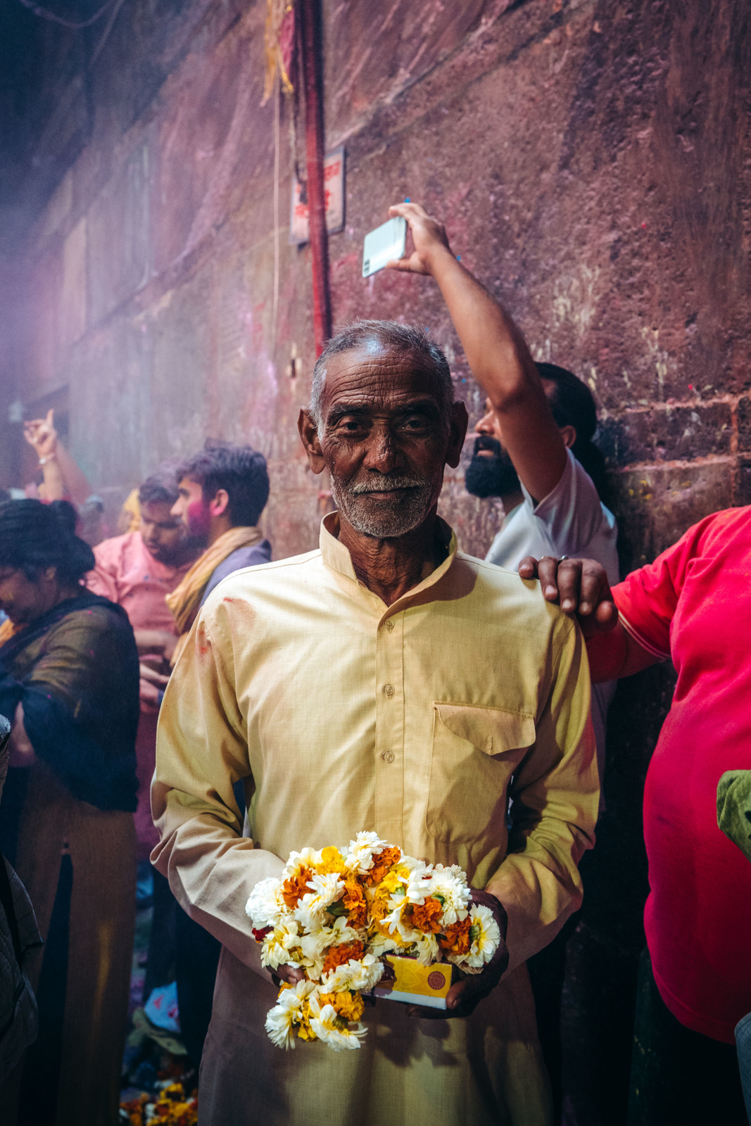 a man holding a bunch of flowers in his hands