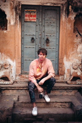 a man sitting on steps in front of a door