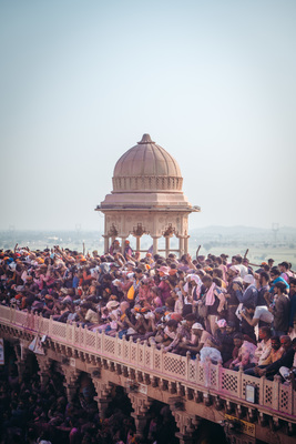 a large crowd of people standing on a bridge