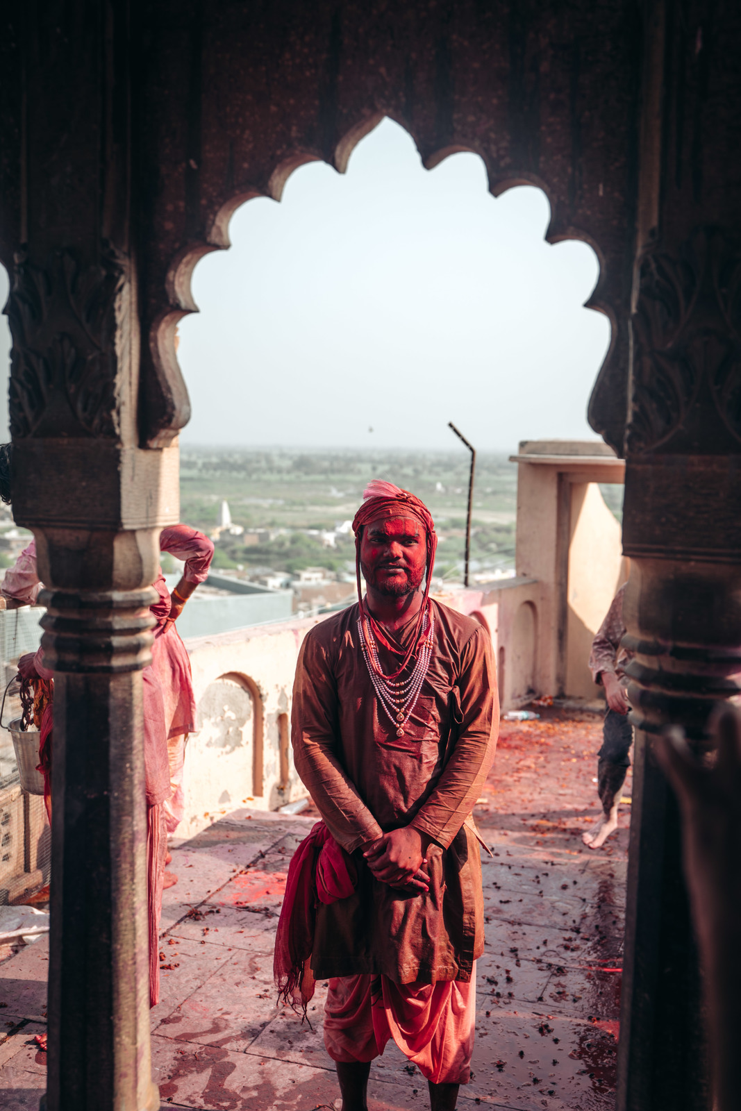 a man in a red turban standing in a doorway