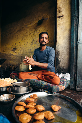 a man sitting in front of a table full of food