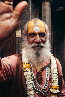 a man with a long beard wearing a yellow and white headdress