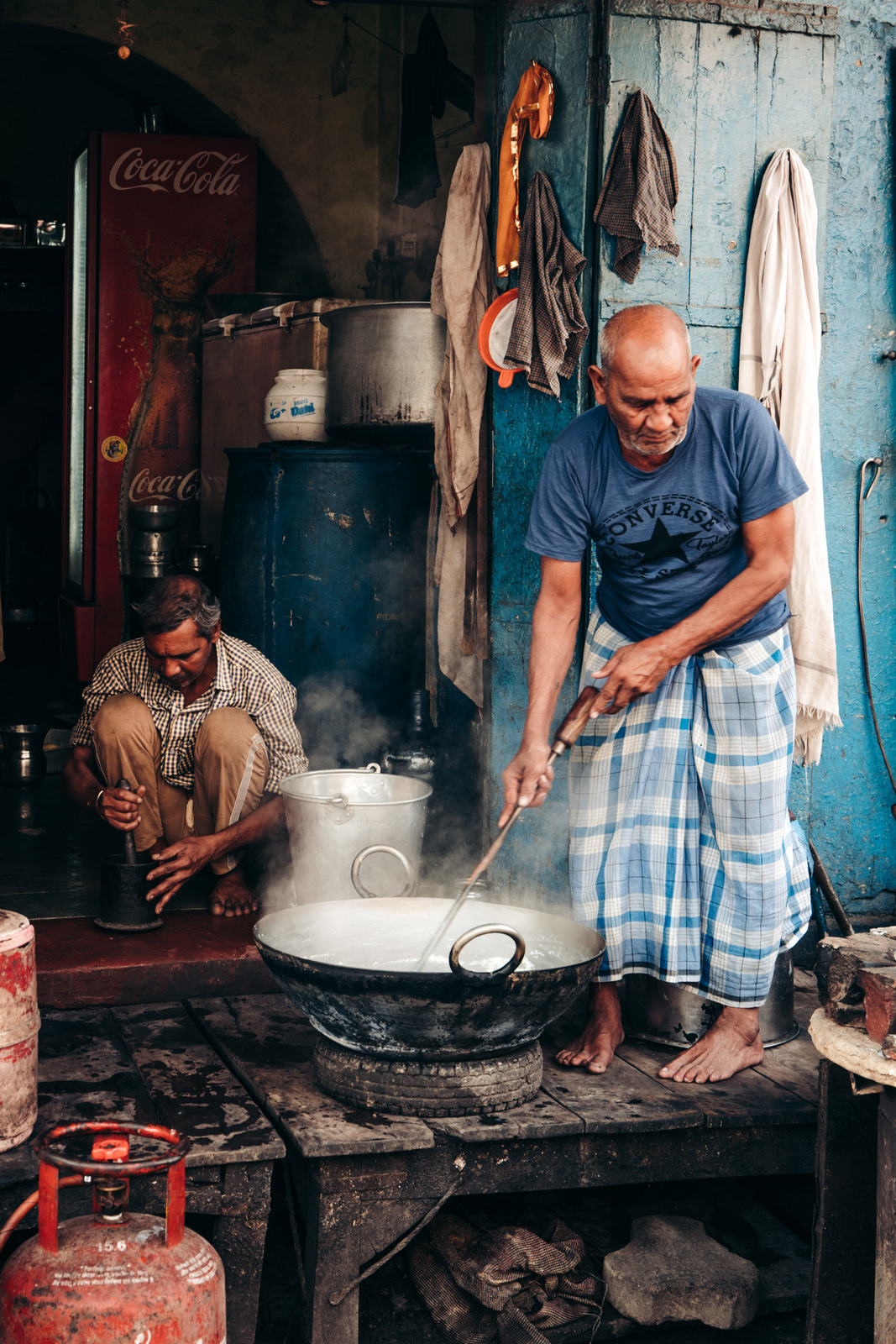 a man cooking food on top of a wok