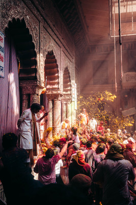 a group of people standing around each other in front of a building