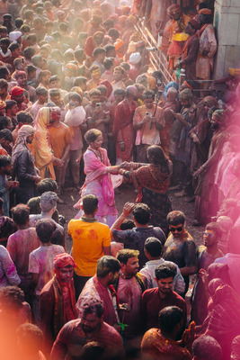 a crowd of people standing around each other