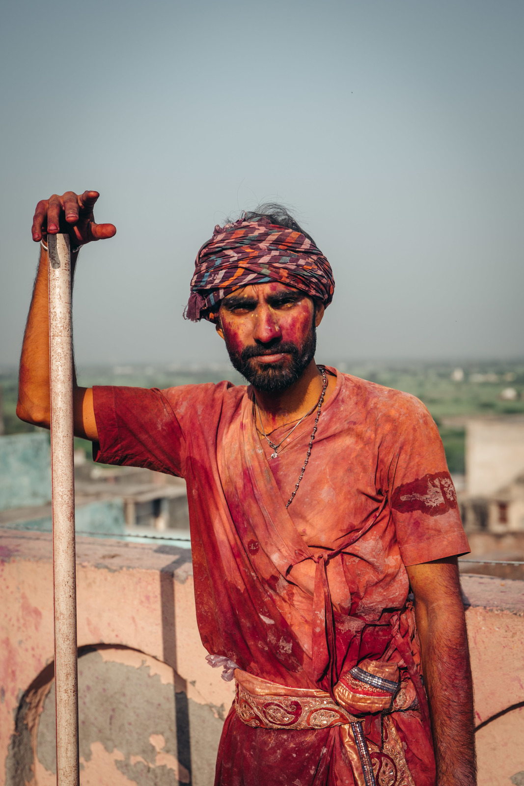 a man with a turban and a stick in his hand