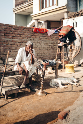 a man sitting on a bench in front of a building