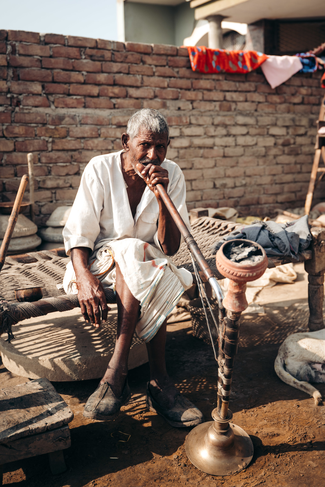 a man sitting on top of a wooden bench