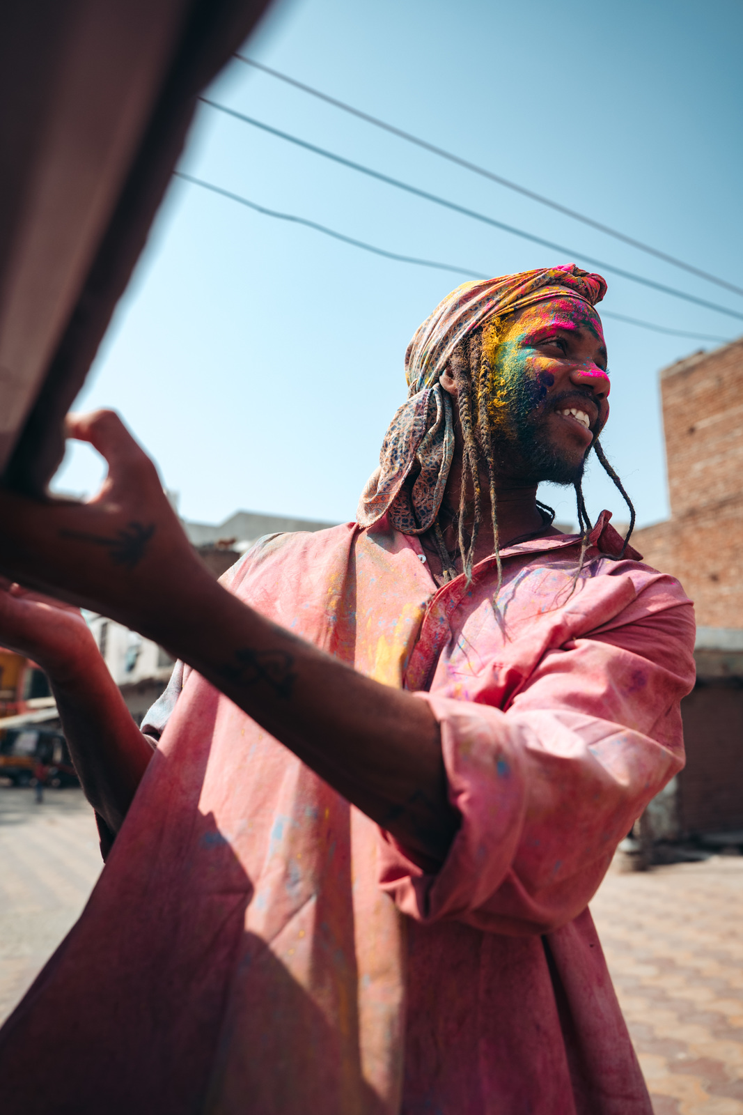 a man with dreadlocks standing in the street