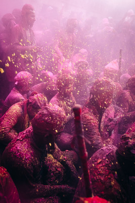 a group of people covered in purple powder